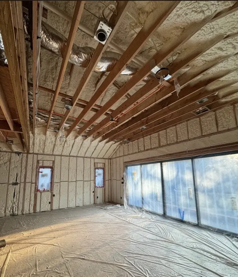 Interior walls and ceiling insulated with spray foam during new construction in Minot